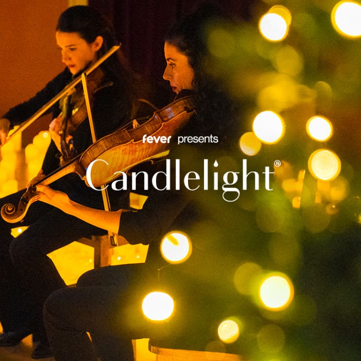 Candlelight concert promotional image with string musicians and warm candlelight