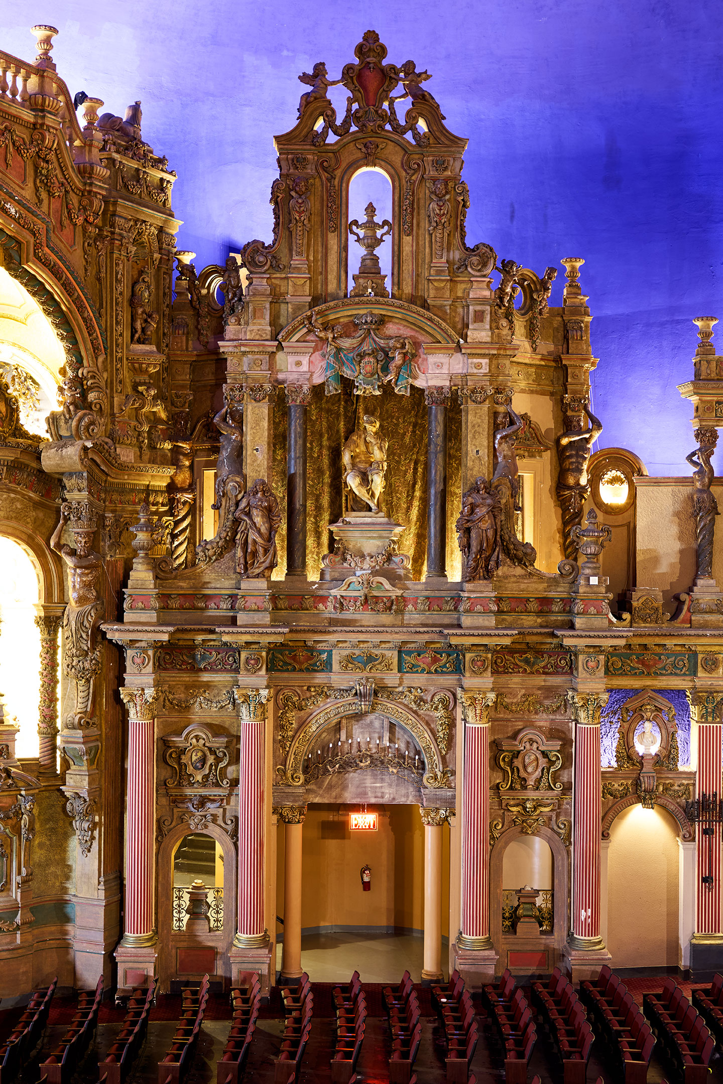 A towering arrangement of arches, columns, and sculpture inside the auditorium.