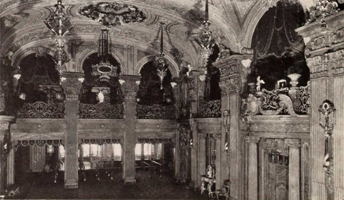 Early black-and-white photograph of the Paradise foyer with painted ceilings, chandeliers, and ornate balconies