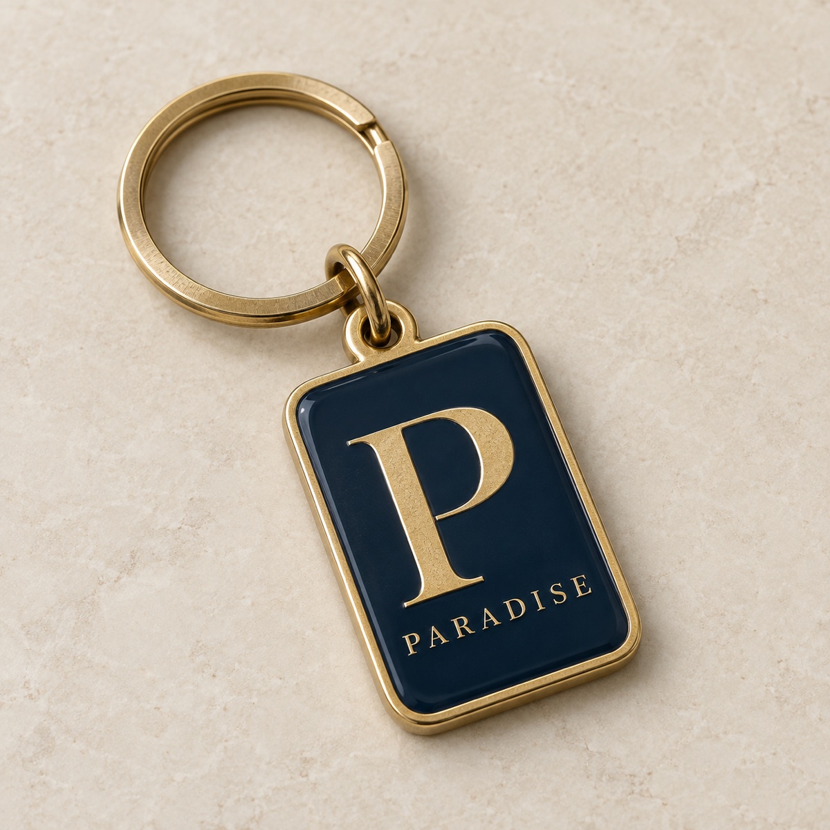 Realistic concept mockup of a navy enamel and brass Paradise keychain