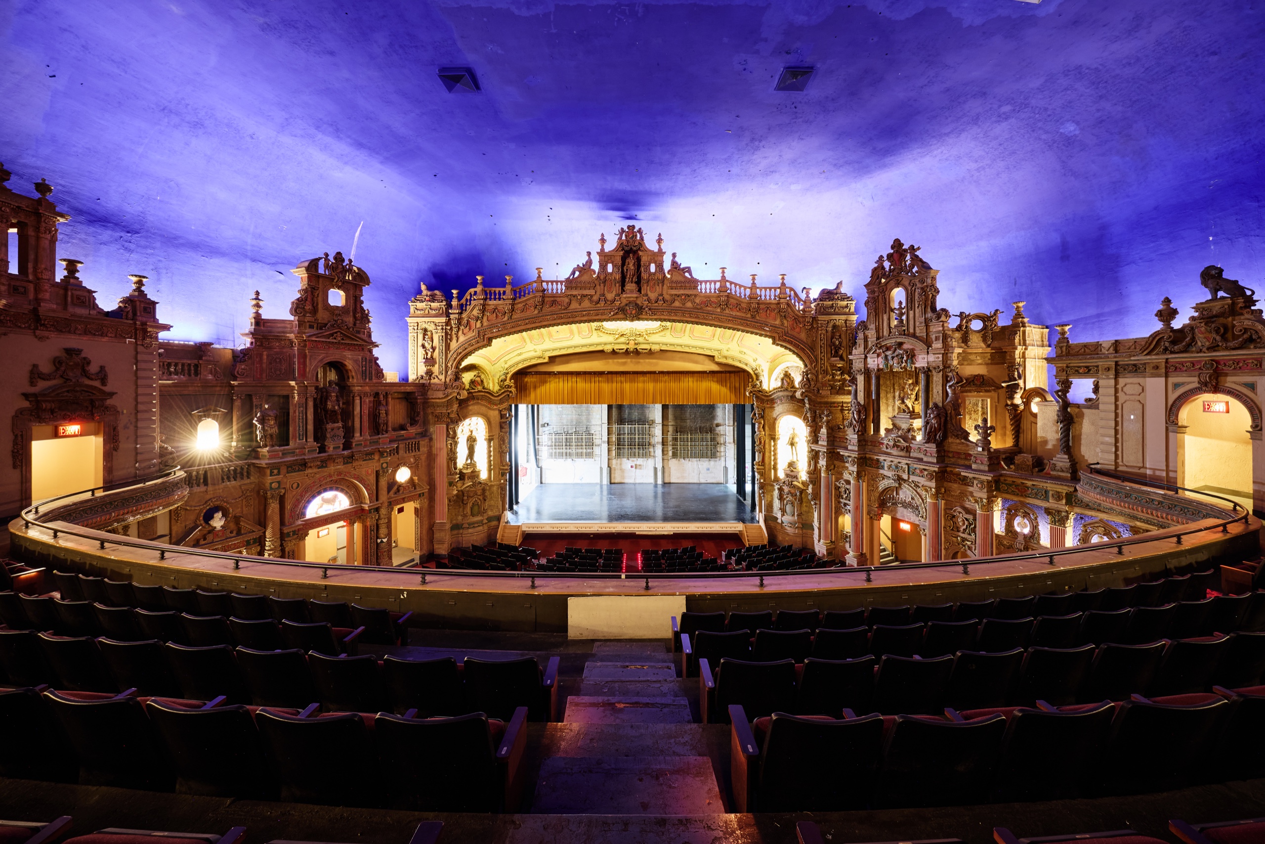 The Paradise auditorium and golden stage beneath a vivid blue ceiling